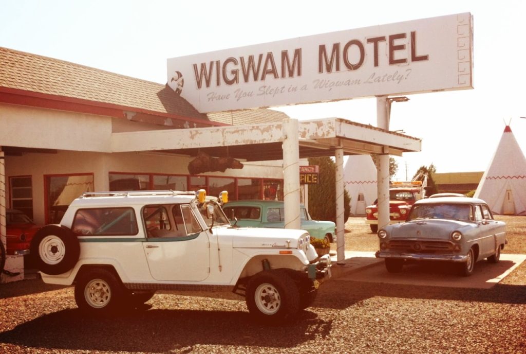 Kate Cooks '66 Jeepster parked at the wigwam motel 