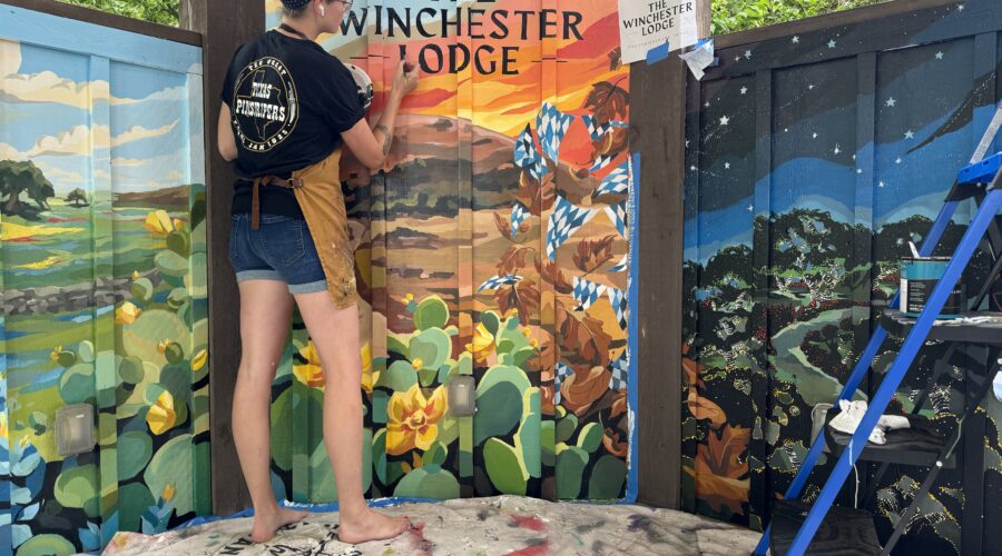 Kate Cook paints a mural at the Winchester Lodge